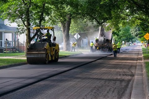 City crews pave a street in the Northside neighborhood